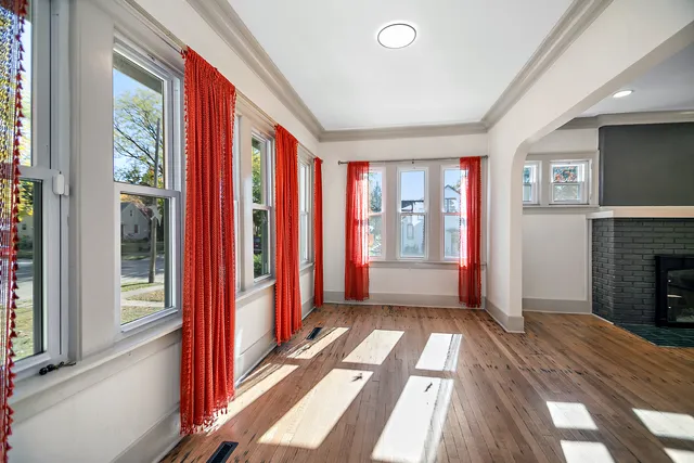 a view of hallway with furniture and a fireplace