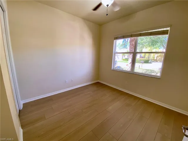 an empty room with closet and mirror