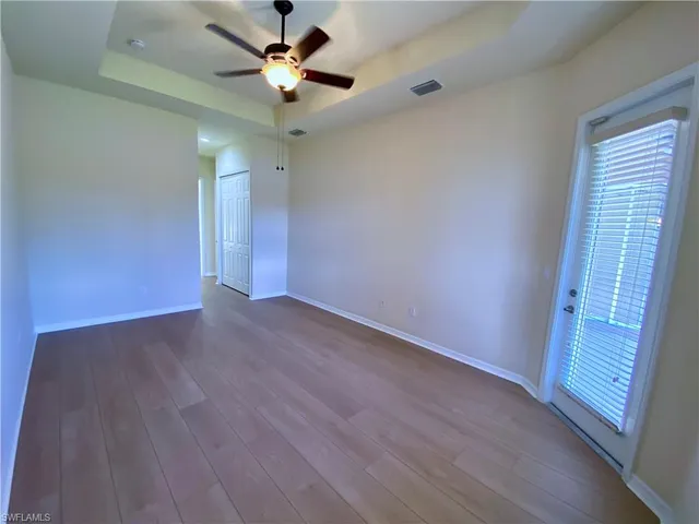 a view of room with window and wooden floor