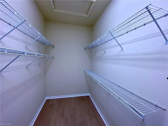 a spacious bathroom with a granite countertop sink a mirror and a shower