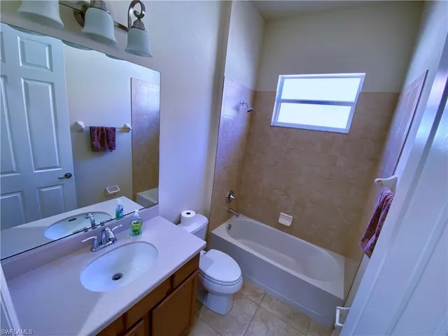 a bathroom with a sink a toilet and bathtub