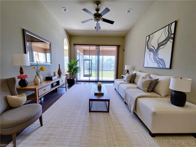 a dining room with furniture a chandelier and wooden floor