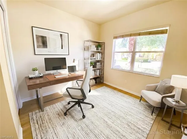 a spacious bedroom with a bed a couch and a chandelier