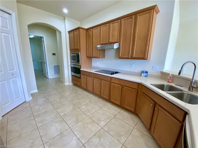 a kitchen with stainless steel appliances a sink cabinets and a counter top space