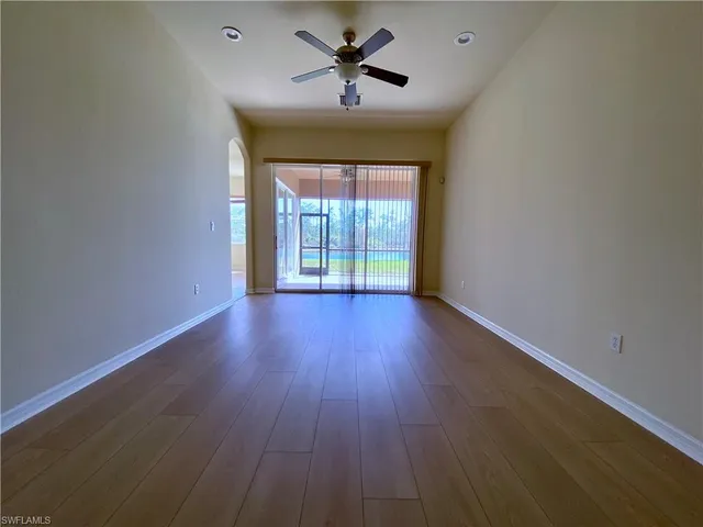 a view of a chandelier fan and fire place