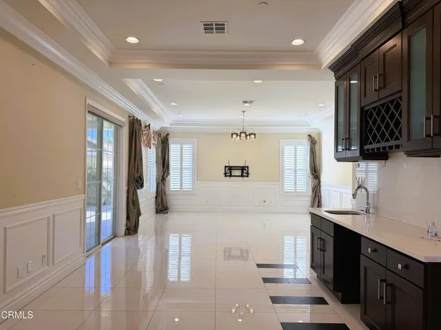 a large white kitchen with a sink and cabinets