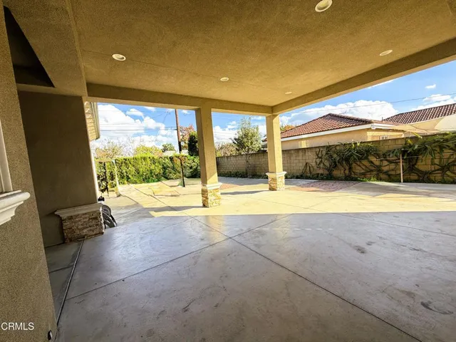 a view of an empty room with a floor to ceiling window and pool table