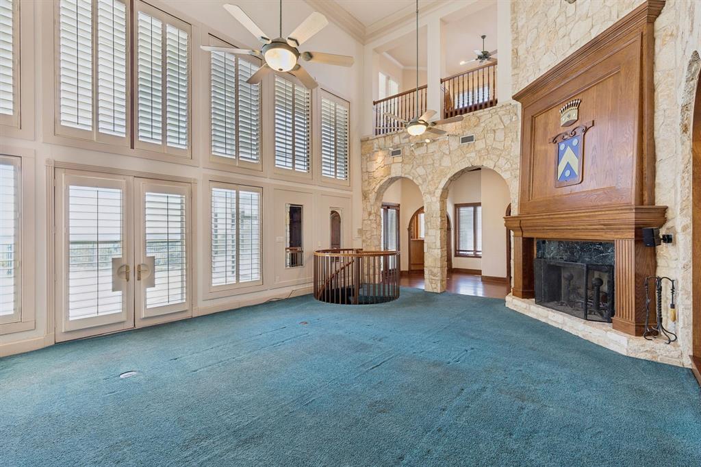 9888 Boat Club Road Fort Worth, TX 76179 - Photo 22 of 38 a view of livingroom with fireplace fan and windows