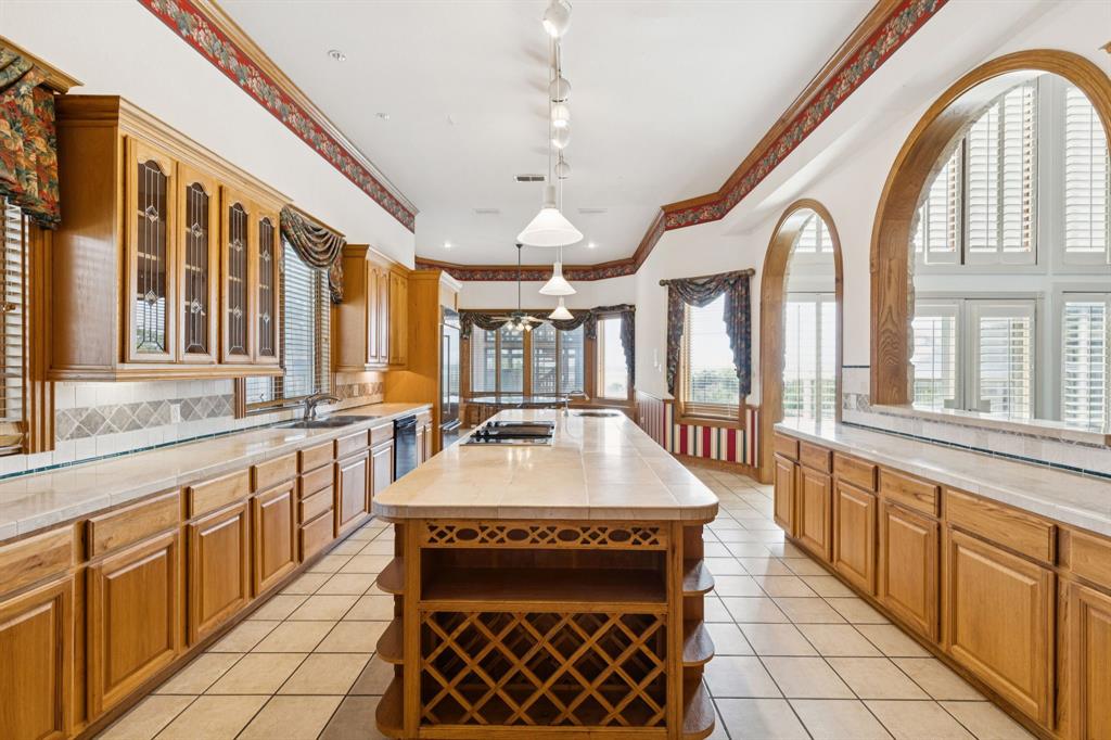 9888 Boat Club Road Fort Worth, TX 76179 - Photo 25 of 38 a large kitchen with stainless steel appliances granite countertop a sink and a large window