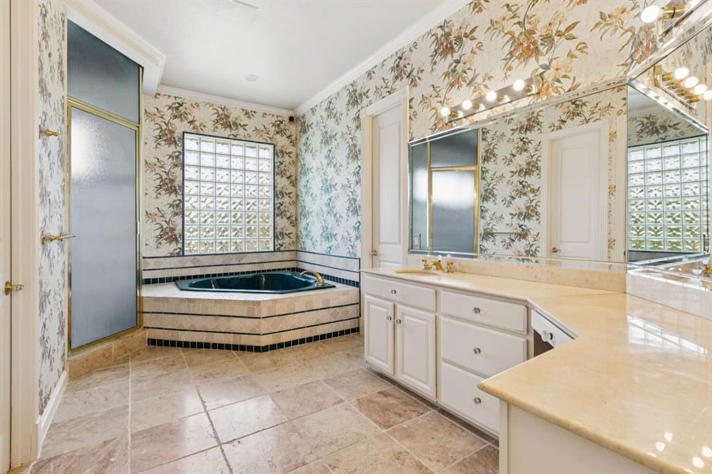 9888 Boat Club Road Fort Worth, TX 76179 - Photo 32 of 38 a bathroom with a tub sink and mirror