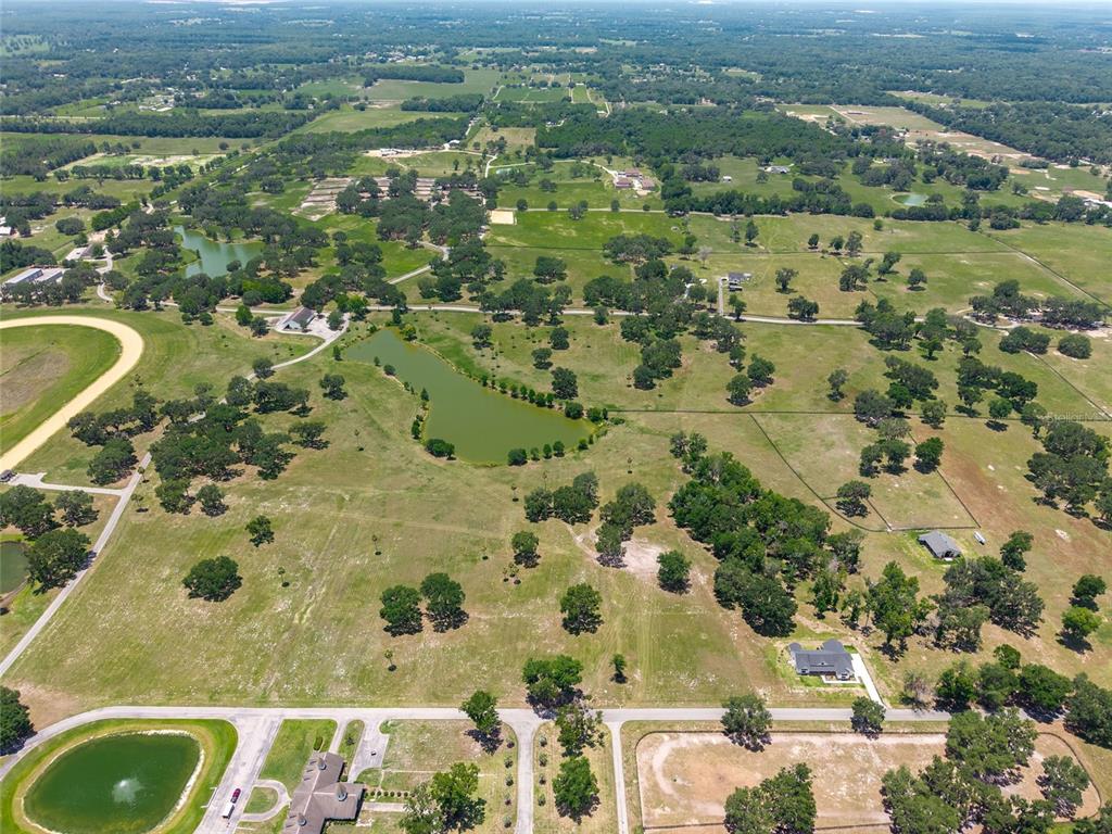 Southeast 61st Terrace Road, Unit 15 Summerfield, FL 34491 - Photo 16 of 18 an aerial view of residential houses with outdoor space