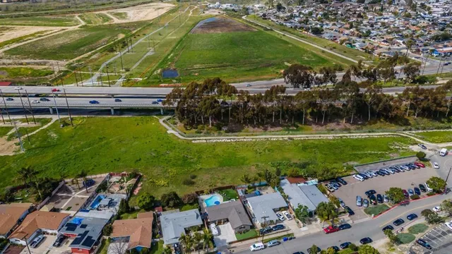 an aerial view of residential houses with outdoor space and trees