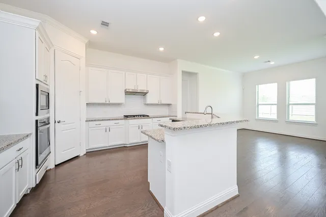 a kitchen with stainless steel appliances a sink stove and refrigerator