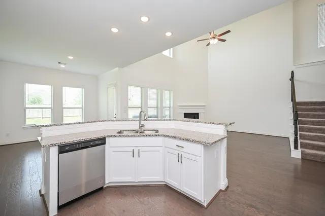 a kitchen with a sink stove and cabinets