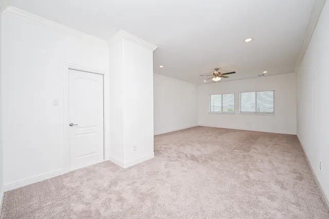 an empty room with windows and closet