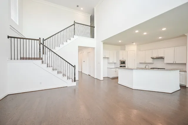 a view of kitchen with stainless steel appliances refrigerator oven and cabinets
