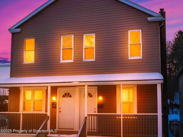 a view of a brick house with a large window