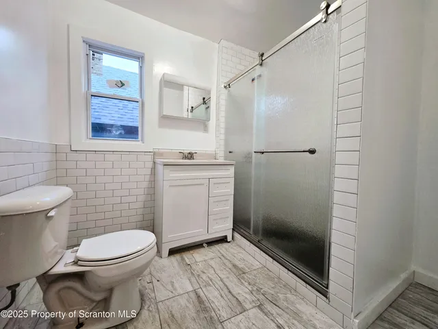 a bathroom with a toilet and a shower