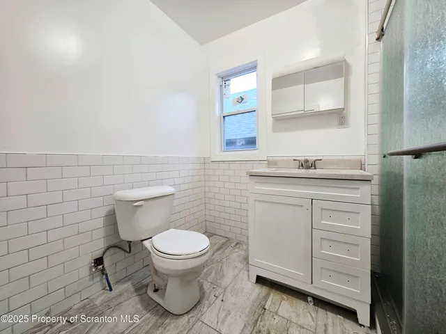 a bathroom with a sink toilet and mirror