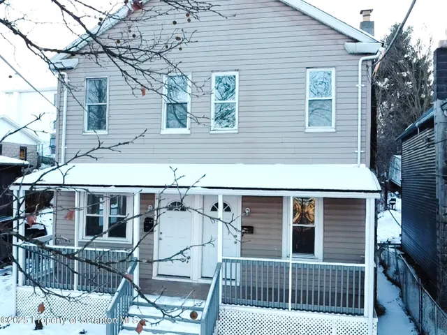a view of a house with iron fence
