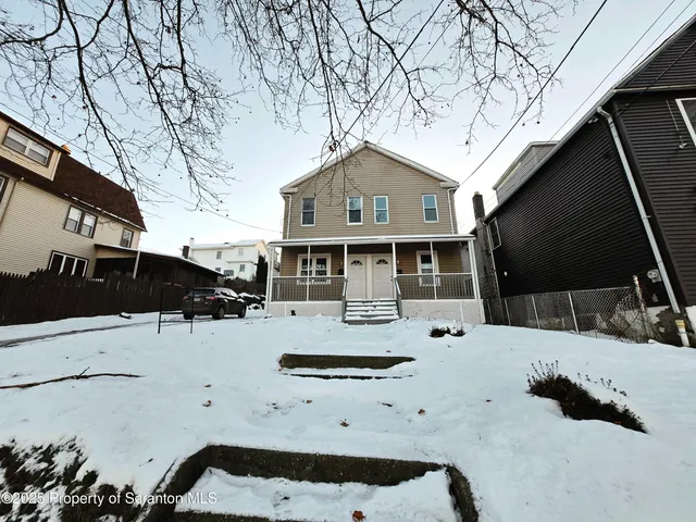 a view of house with a yard