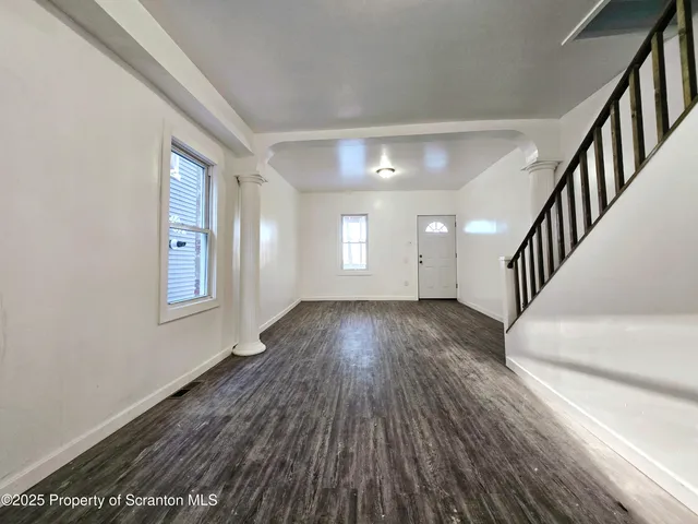 a view of livingroom with hardwood and stairs