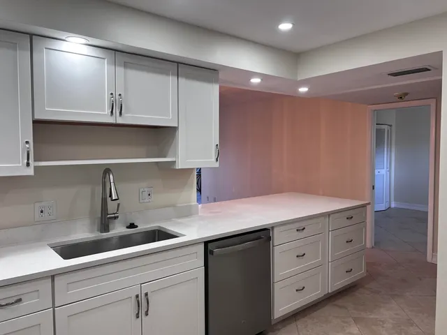 a kitchen with white cabinets