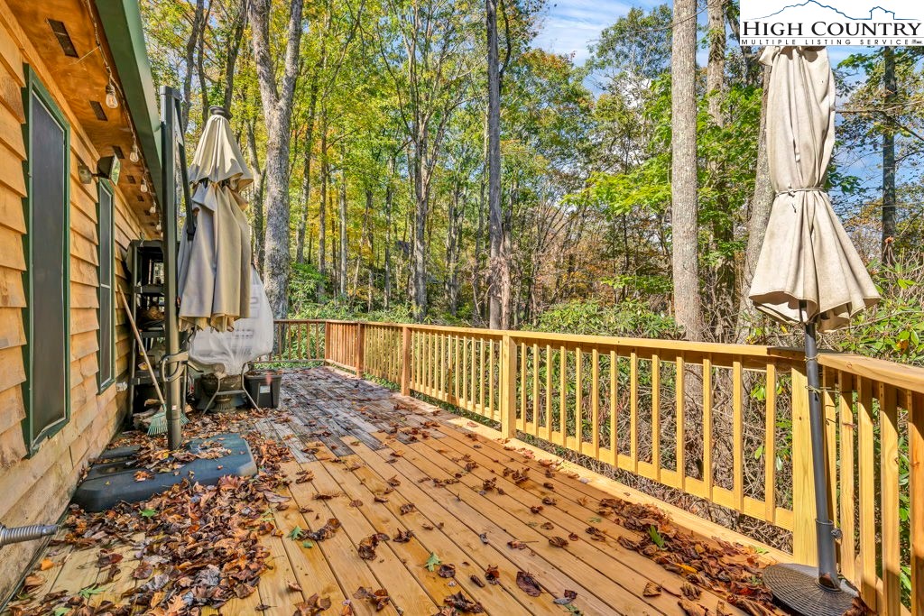 180 Wild Blackberry Hill Road Boone, NC 28607 - Photo 25 of 30 a view of roof deck with wooden floor and fence