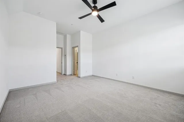 a view of a room with a ceiling fan