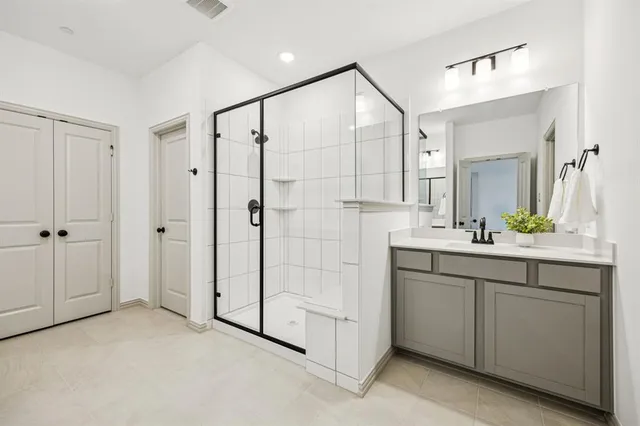 a bathroom with a shower sink and mirror