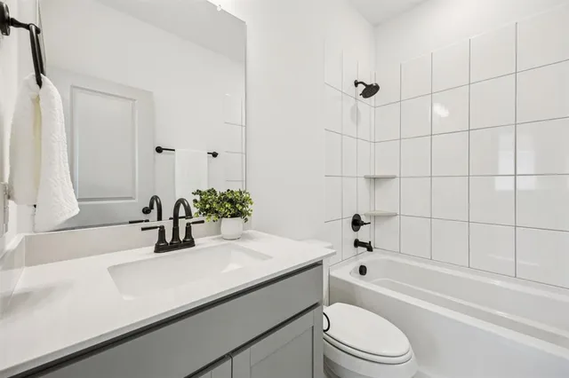 a bathroom with a sink a toilet and bathtub