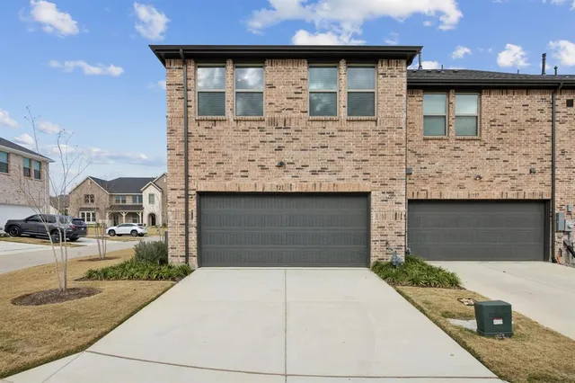 a front view of a house with garage