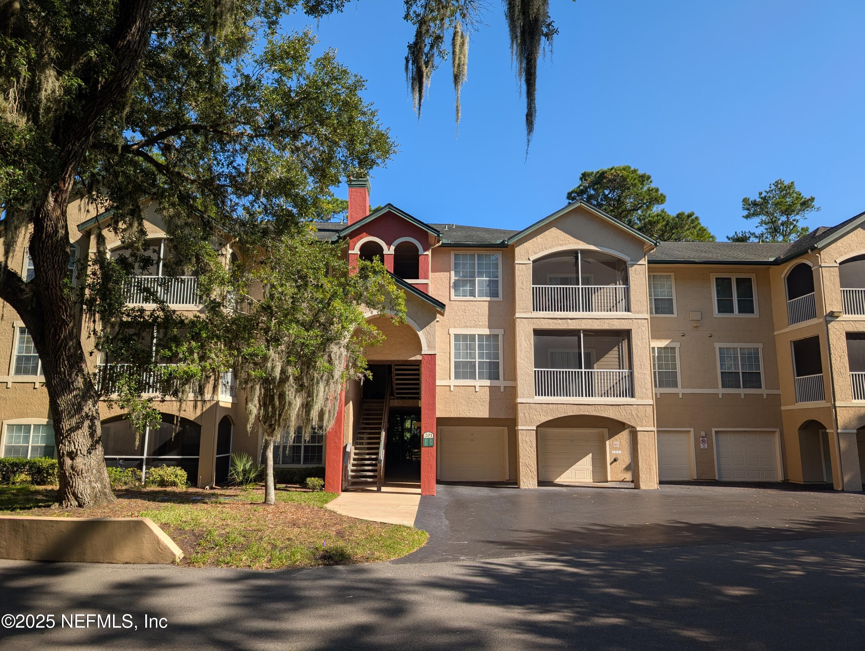 201 Colima Court, Unit 1221 Ponte Vedra Beach, FL 32082 - Photo 1 of 50 a front view of a house with a yard
