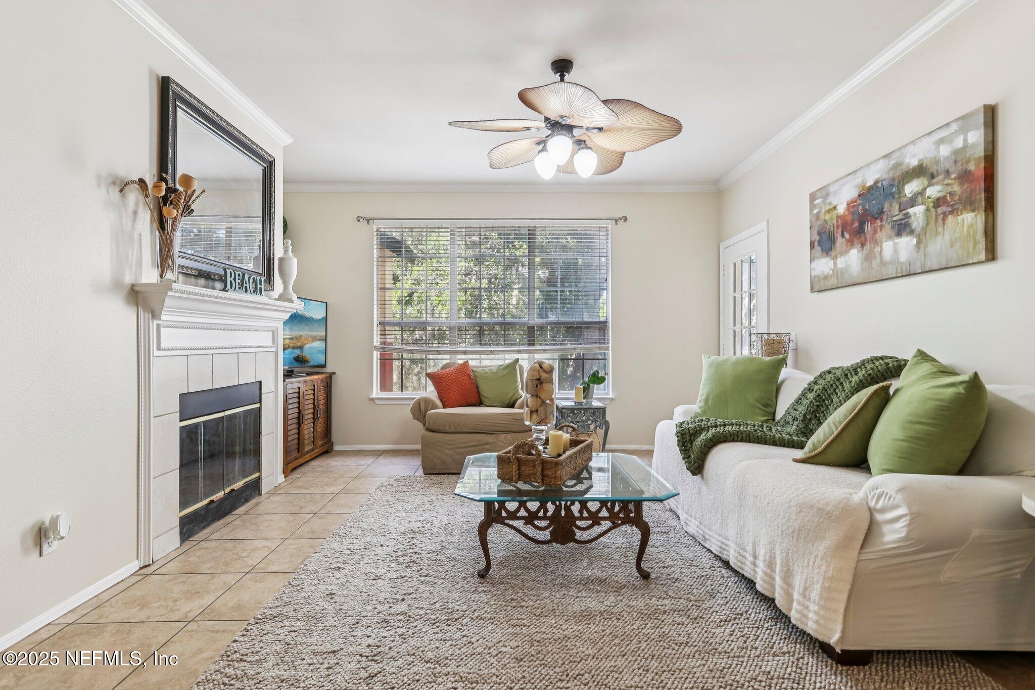201 Colima Court, Unit 1221 Ponte Vedra Beach, FL 32082 - Photo 13 of 50 a living room with furniture a fireplace and a flat screen tv