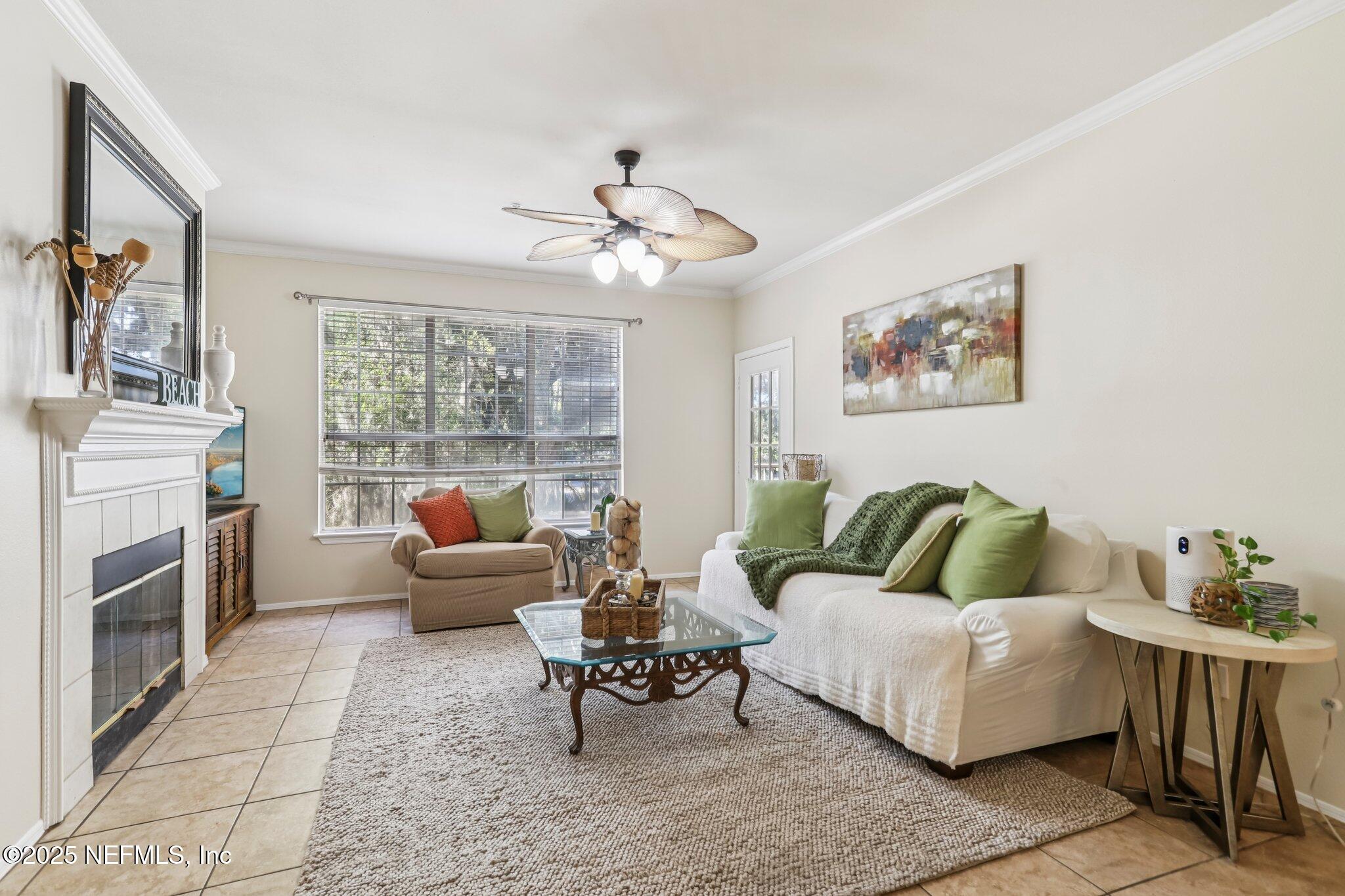 201 Colima Court, Unit 1221 Ponte Vedra Beach, FL 32082 - Photo 14 of 50 a living room with furniture a fireplace and a flat screen tv