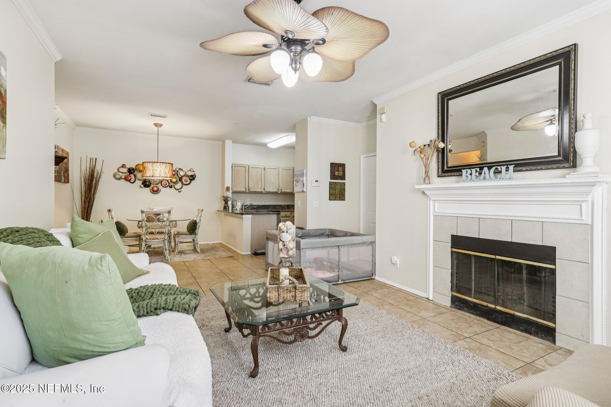 201 Colima Court, Unit 1221 Ponte Vedra Beach, FL 32082 - Photo 18 of 50 a living room with furniture a fireplace and a flat screen tv