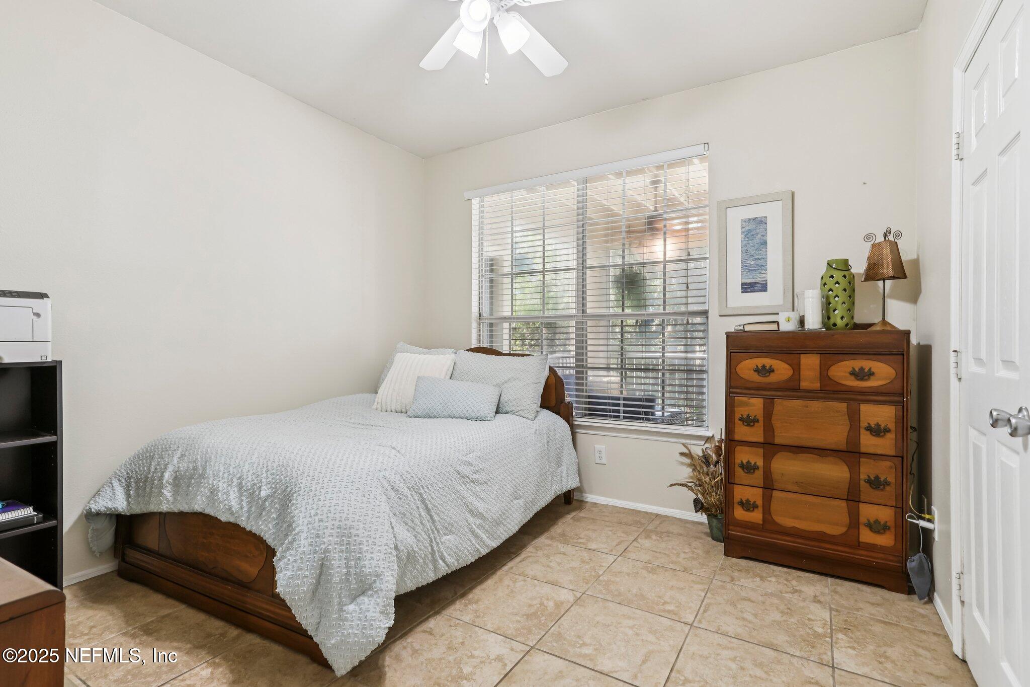 201 Colima Court, Unit 1221 Ponte Vedra Beach, FL 32082 - Photo 24 of 50 a bedroom with a bed and a window