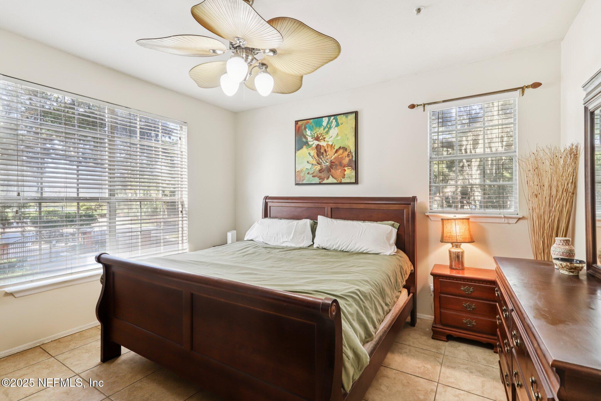 201 Colima Court, Unit 1221 Ponte Vedra Beach, FL 32082 - Photo 32 of 50 a bedroom with a bed and a large window