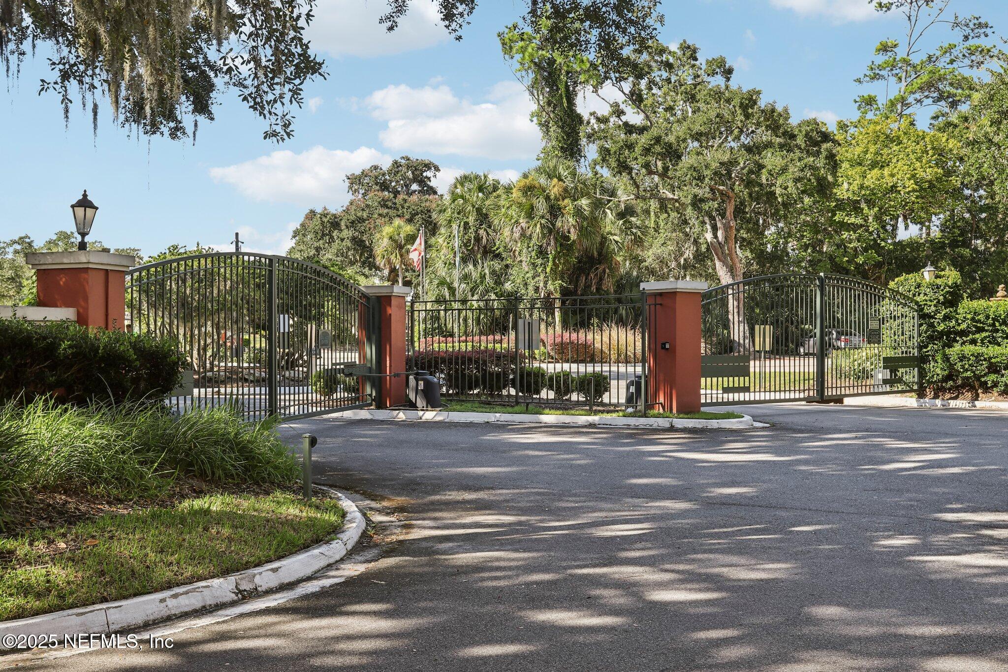 201 Colima Court, Unit 1221 Ponte Vedra Beach, FL 32082 - Photo 37 of 50 a front view of a house with a yard and trees
