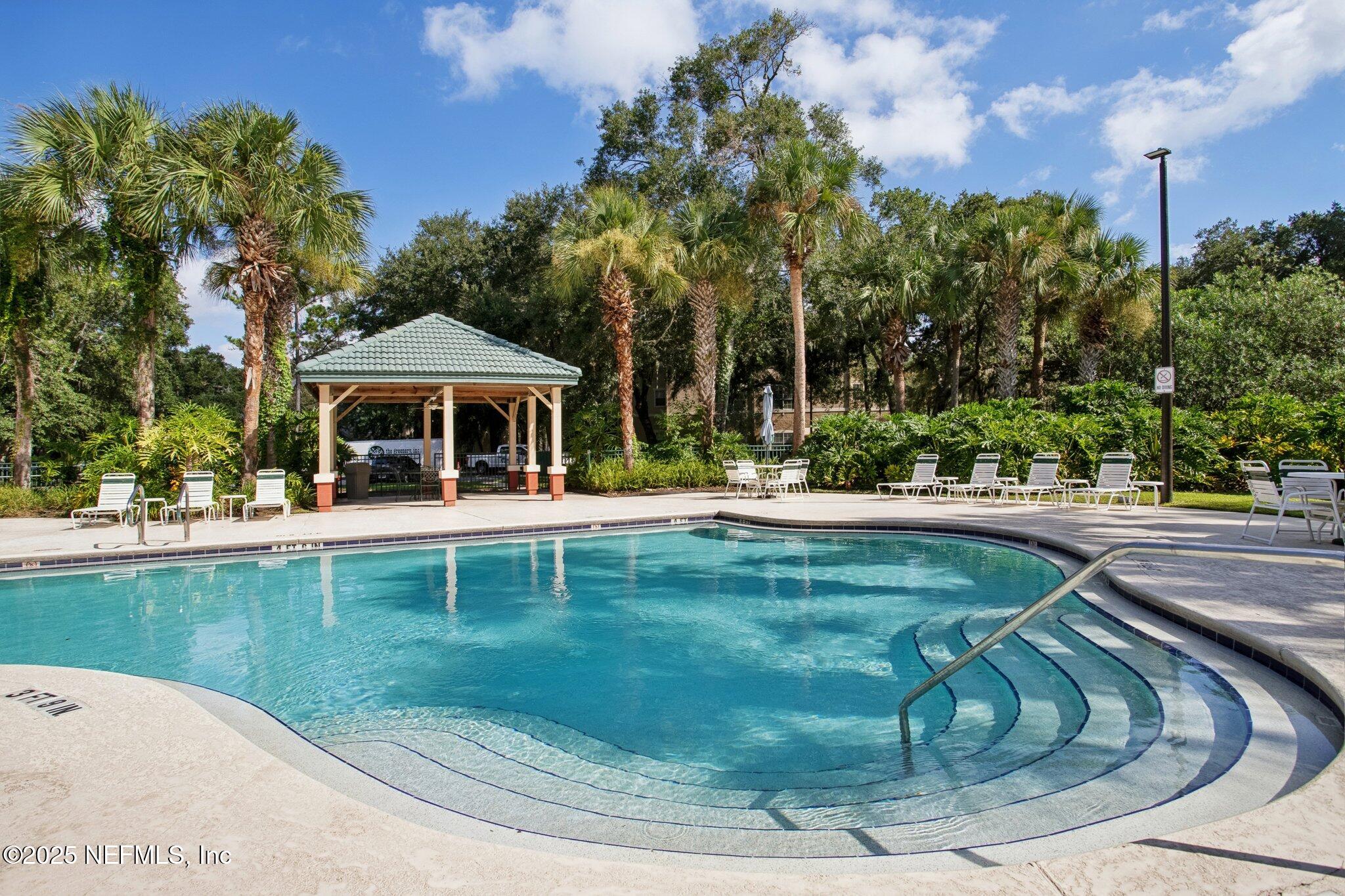 201 Colima Court, Unit 1221 Ponte Vedra Beach, FL 32082 - Photo 46 of 50 a view of a swimming pool with a patio