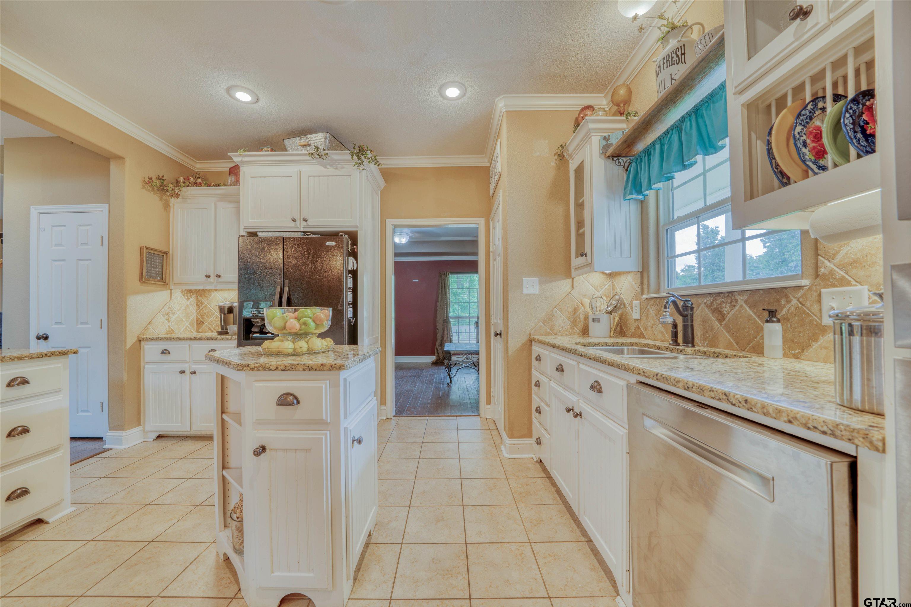 1776 Mustang Road Gilmer, TX 75645 - Photo 20 of 45 a large kitchen with stainless steel appliances kitchen island granite countertop a sink and cabinets