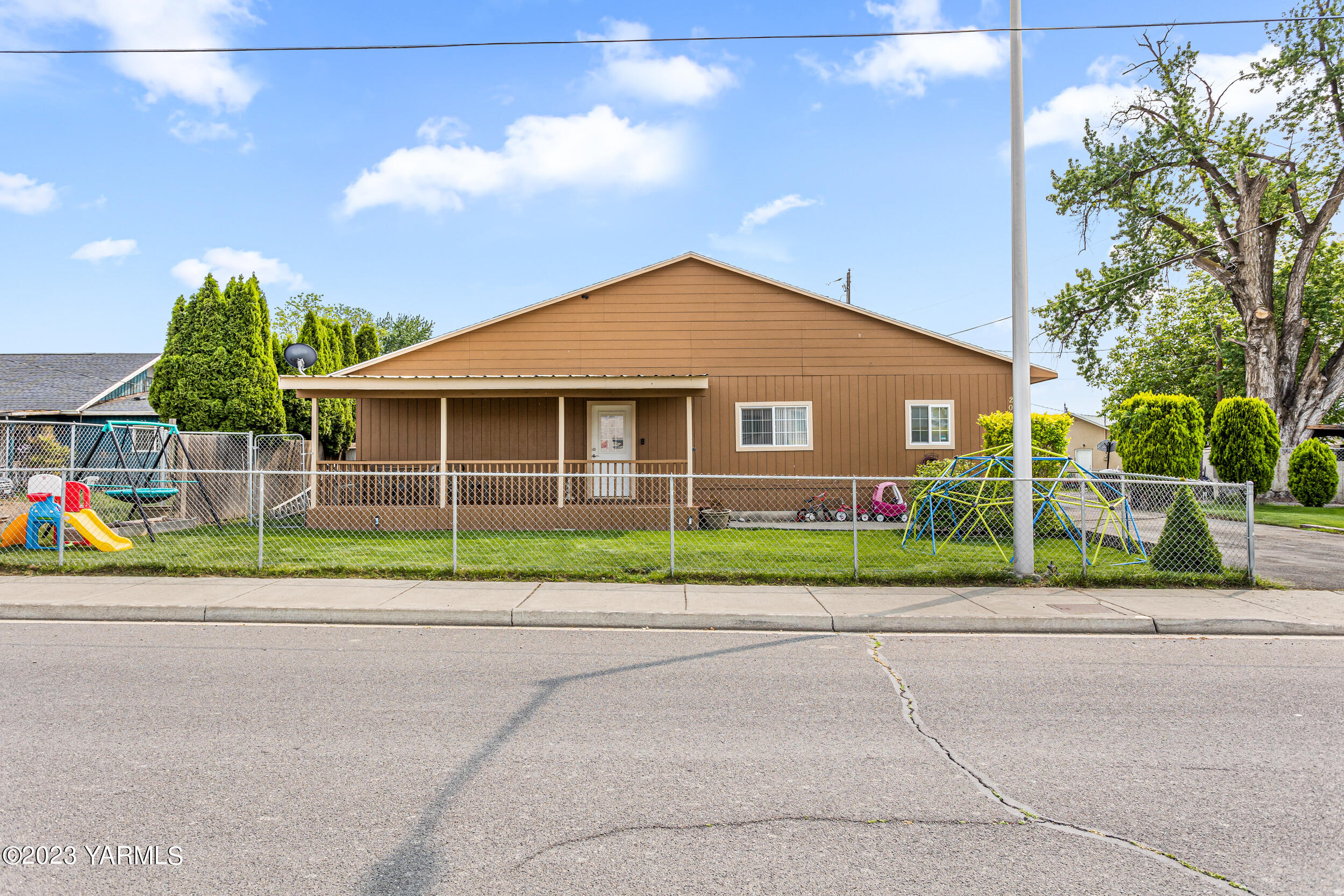 202 West Charron Road Moxee, WA 98936 - Photo 1 of 39 a view of green house with a big yard and potted plants