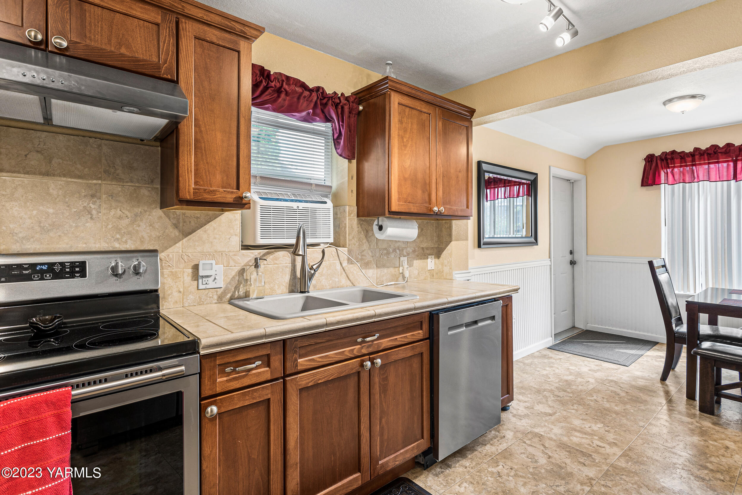 202 West Charron Road Moxee, WA 98936 - Photo 17 of 39 a kitchen with a sink cabinets and wooden floor