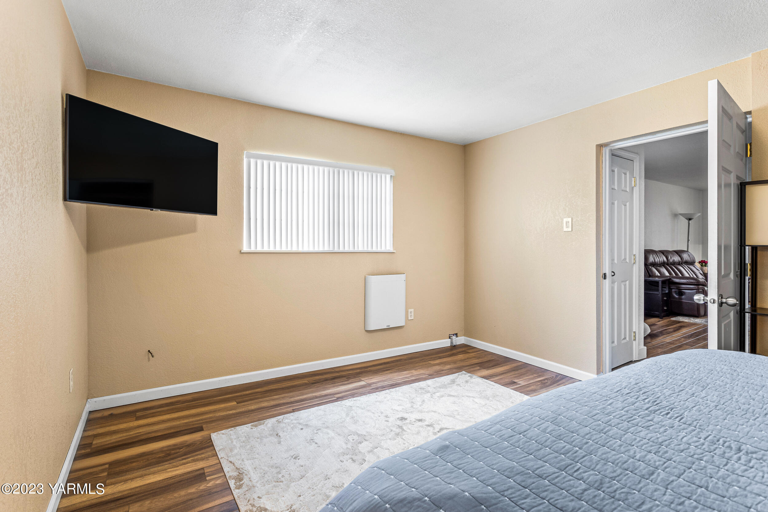 202 West Charron Road Moxee, WA 98936 - Photo 19 of 39 a bedroom with a bed and a flat screen tv