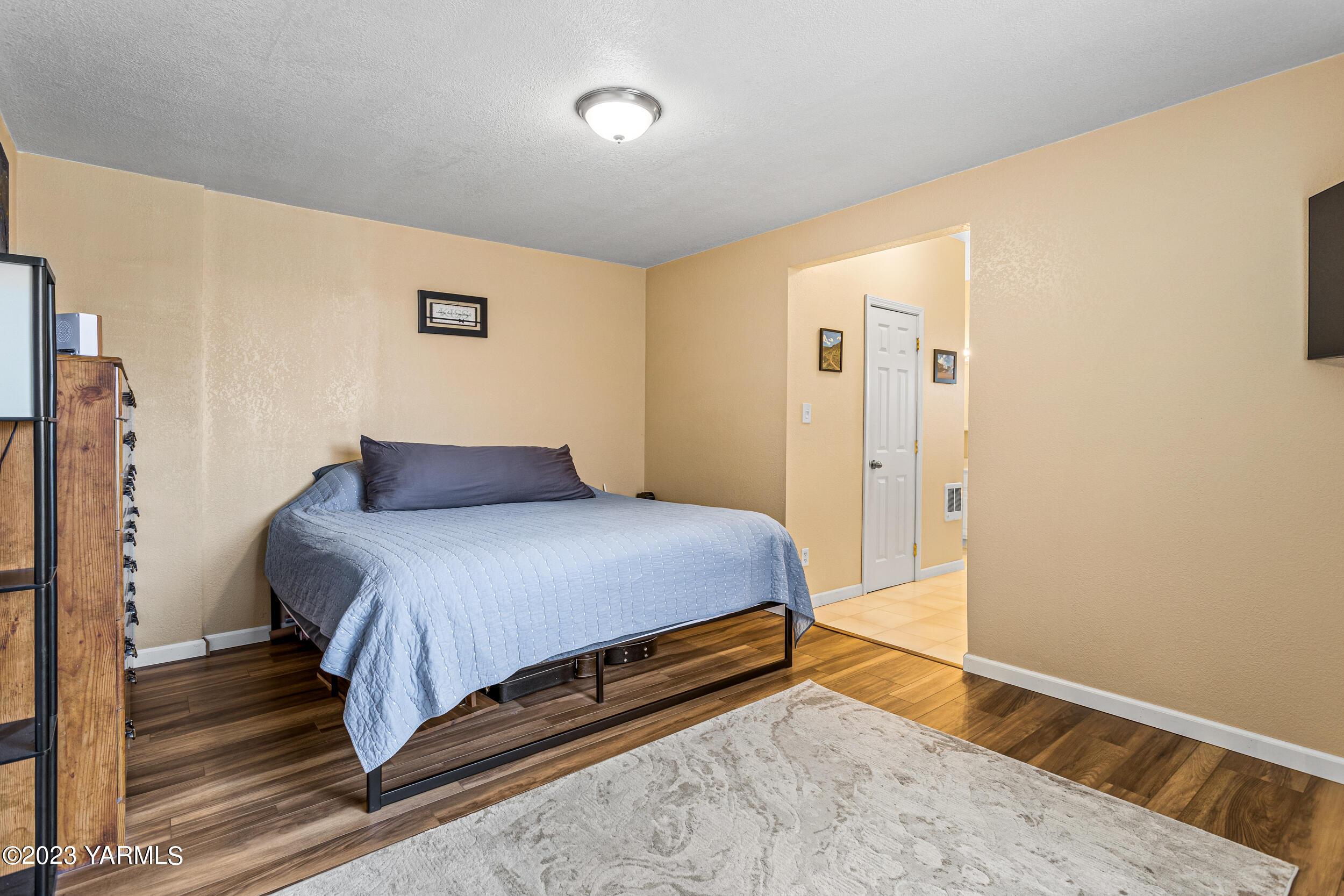 202 West Charron Road Moxee, WA 98936 - Photo 20 of 39 a bedroom with a bed and wooden floor