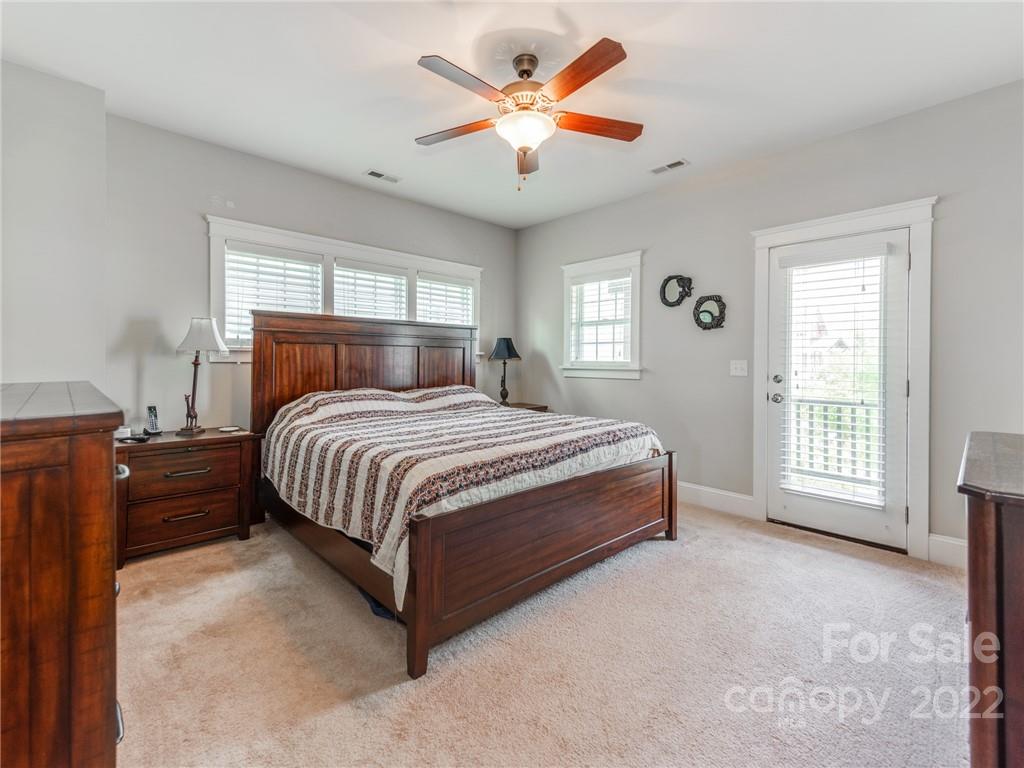 326 Mariemont Way Rock Hill, SC 29730 - Photo 19 of 36 a bedroom with a large bed a chandelier and a window