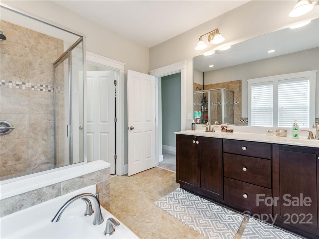 326 Mariemont Way Rock Hill, SC 29730 - Photo 23 of 36 a spacious bathroom with a sink a mirror a vanity and a bathtub