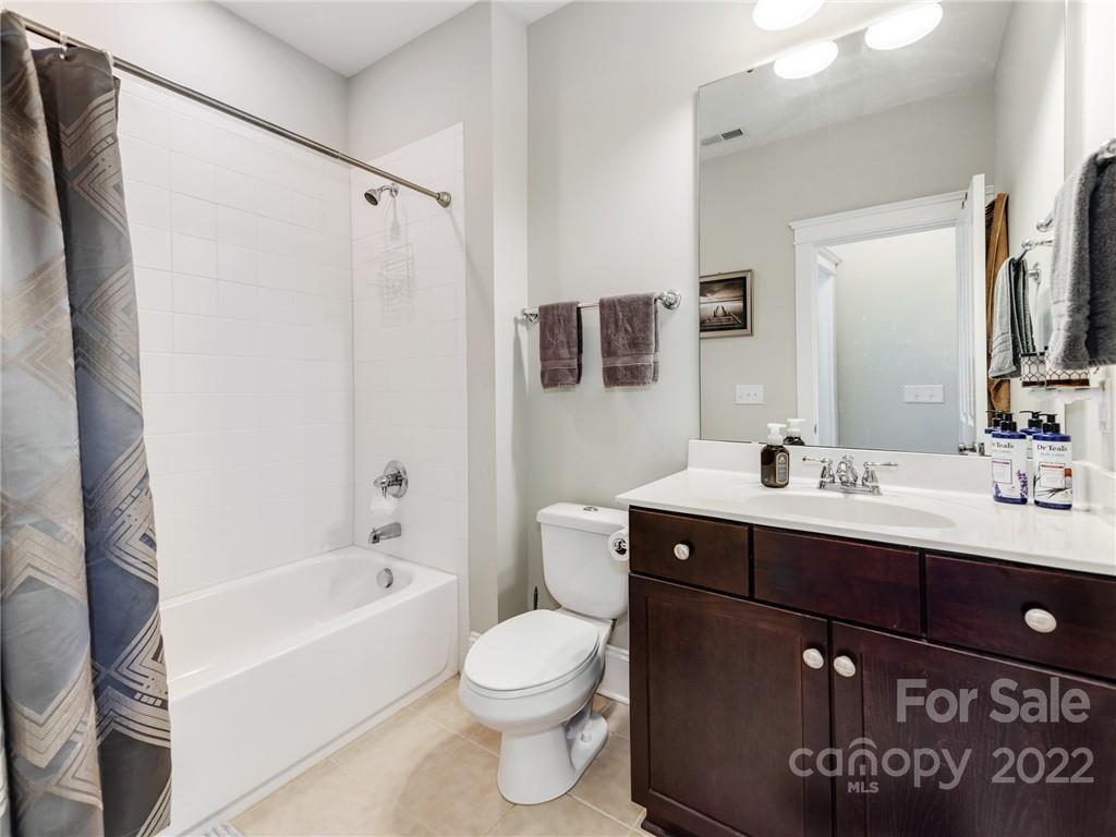 326 Mariemont Way Rock Hill, SC 29730 - Photo 27 of 36 a bathroom with a sink a toilet a mirror a bathtub and shower