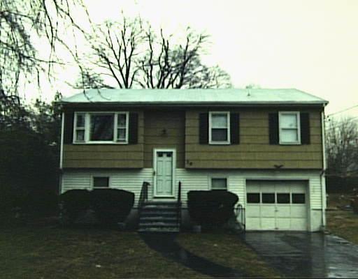 a front view of a house with parking space