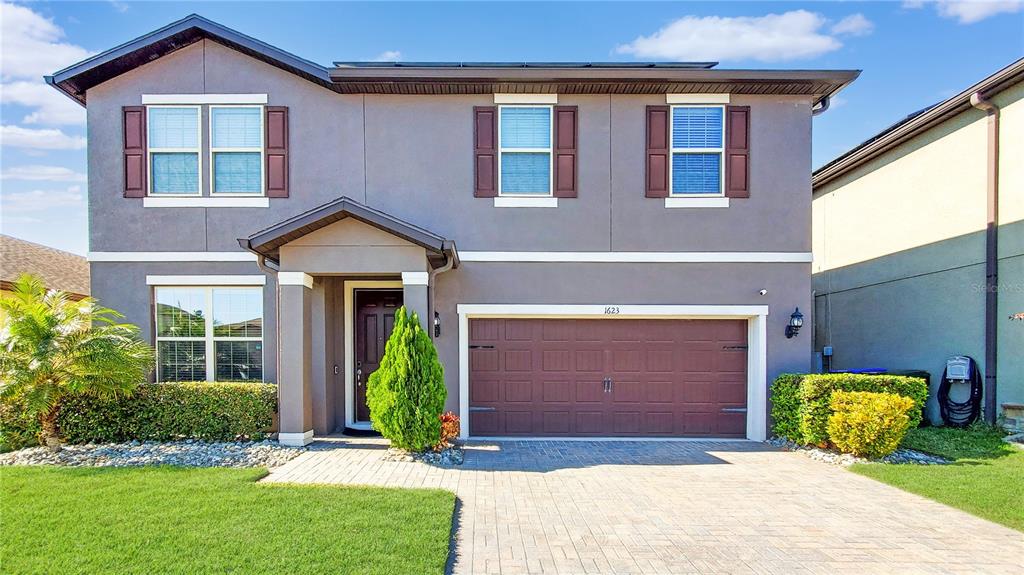 a front view of a house with garden